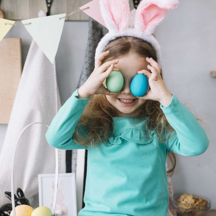 cute girl bunny ears holding colored eggs eyes scaled