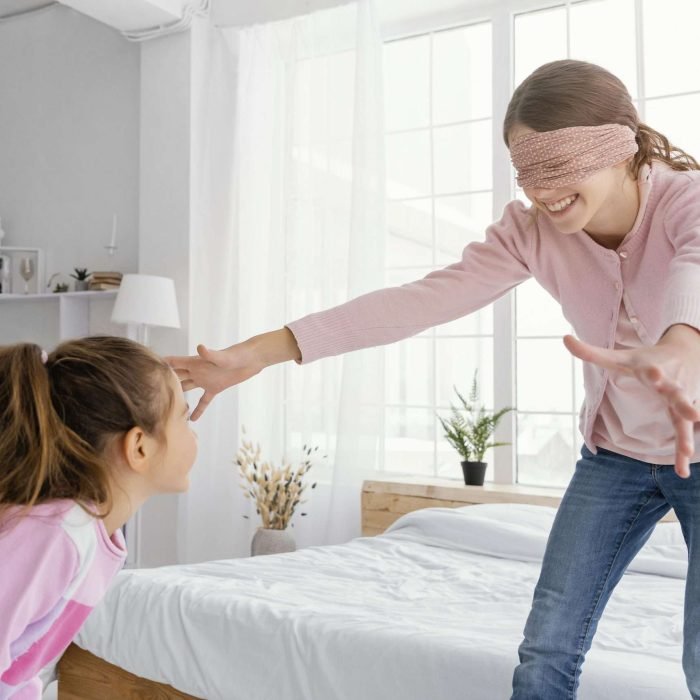 two sisters playing home while blindfolded scaled